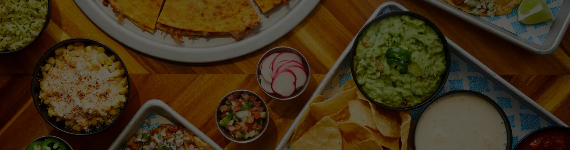 Rreal Tacos dishes — quesadilla, guacamole, chips and sides